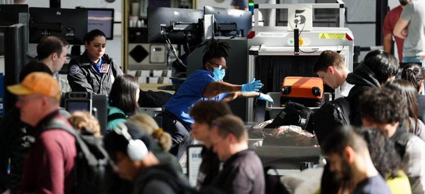 Passengers wait in line for a TSA security checkpoint while traveling at Los Angeles International Airport on Nov. 26, 2025. TSA workers could soon miss their first full paycheck due to the most recent partial government shutdown.