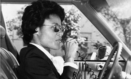 Special Agent Johnnie Gibson uses a car radio on assignment in the 1970s. Gibson was the first Black female FBI agent. 