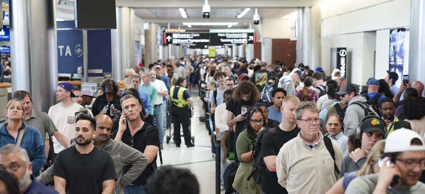 Travelers stand in long lines at Atlanta Hartsfield-Jackson International Airport on March 22, 2026. The travel disruptions continue as hundreds of TSA agents quit or work without pay during a partial government shutdown. President Donald Trump said ICE agents will be deployed to U.S. airports on Monday, with border czar Tom Homan in charge of the effort. 