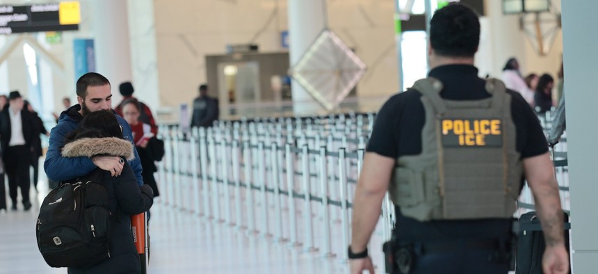 A couple embraces as Immigration and Customs Enforcement (ICE) agents patrol Terminal C at LaGuardia Airport on March 24, 2026 in New York City. The travel disruptions continue as hundreds of TSA agents quit or work without pay during a partial government shutdown. President Donald Trump deployed ICE agents to U.S. airports on Monday, with border czar Tom Homan in charge of the effort.