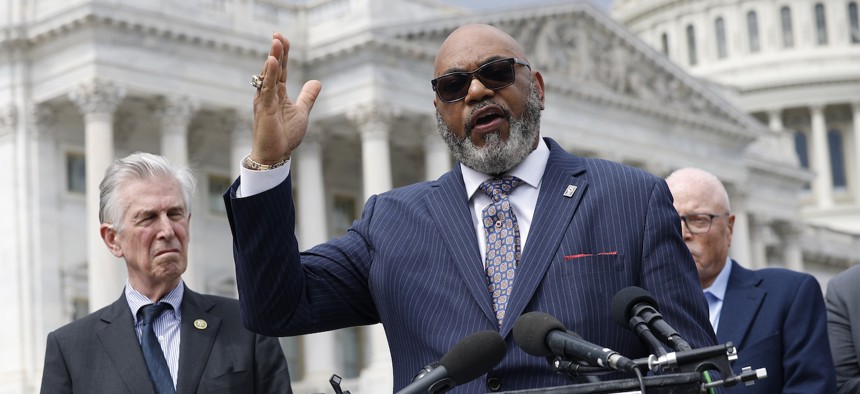 Everett Kelley (center), national president of the American Federation of Government Employees, warned that the move could portend Trump’s appointees to the authority putting their thumbs on the scale against unions.