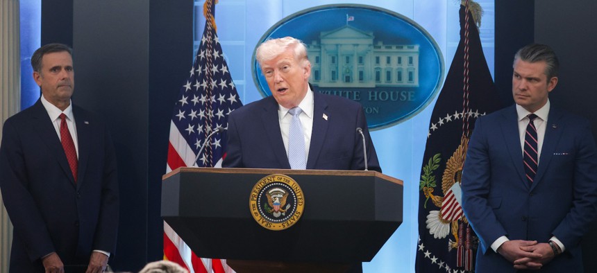 President Donald Trump speaks alongside Central Intelligence Agency Director John Ratcliffe (left) and Defense Secretary Pete Hegseth during a news conference at the White House.