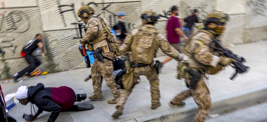 National Guard members arrest a protester in front of the Metropolitan Detention Center in Los Angeles in June 2025.