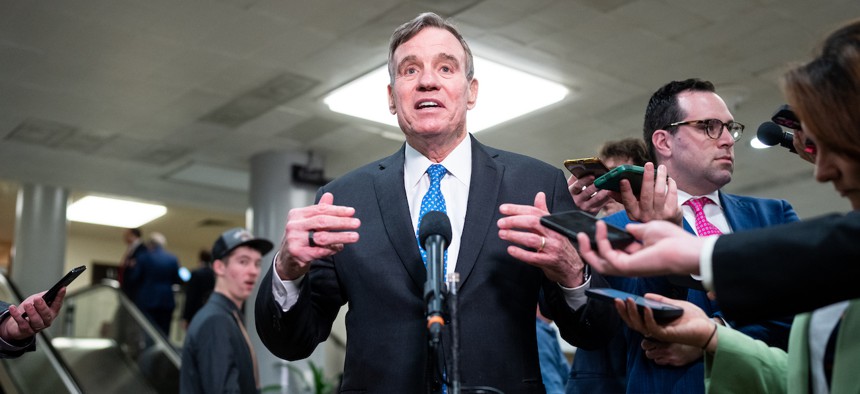 Sen. Mark Warner, D-Va., led 14 senators in asking OPM to rescind its request to collect federal employee health care data.