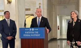 GSA Administrator Ed Forst, flanked by OPM Director Scott Kupor and Sen. Joni Ernst, R-Iowa, announces a relocation of his agency during a press conference on April 20.