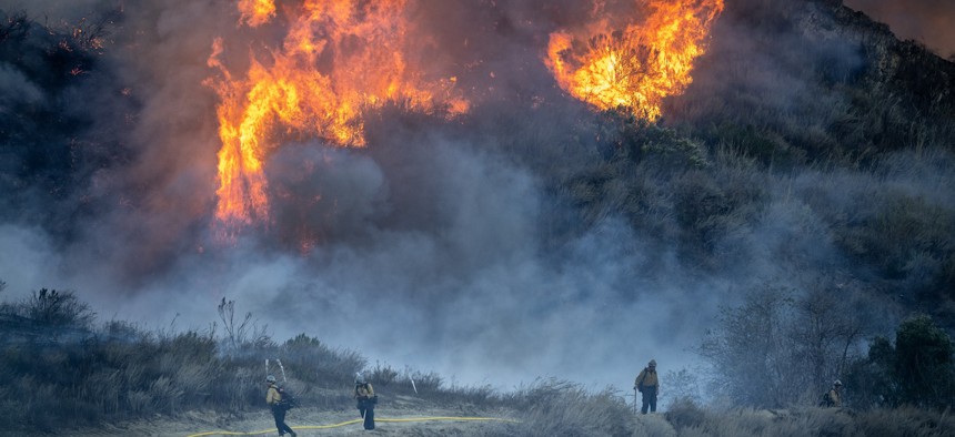 Together the Agriculture and Interior departments employ most federal wildland firefighters.