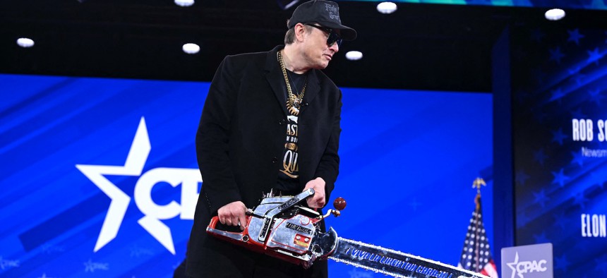 Elon Musk holds a chainsaw reading “Long live freedom, damn it” during the 2025 Conservative Political Action Conference. Musk took the helm of DOGE, the Trump administration’s Department of Government Efficiency, and oversaw cuts and reorganizations across federal agencies.