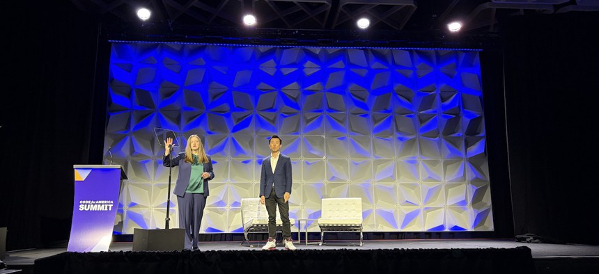 Jana Rhyu (left) and Michael Lai announce Code for America and Anthropic's partnership to develop AI-based tools to streamline benefits administration for caseworkers at the annual Code for America Summit on May 8, 2026, in Chicago.