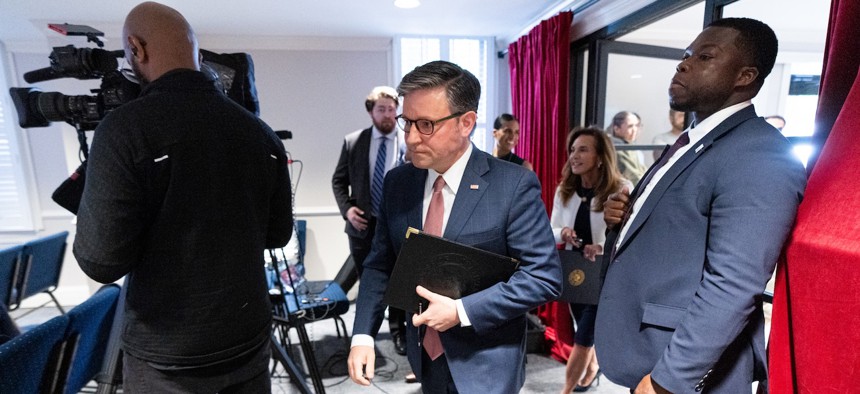 House Speaker Mike Johnson, R-La., (center) arrives for the news conference following the House Republican Conference caucus meeting at the Republican National Committee headquarters on May 13, 2026. 
