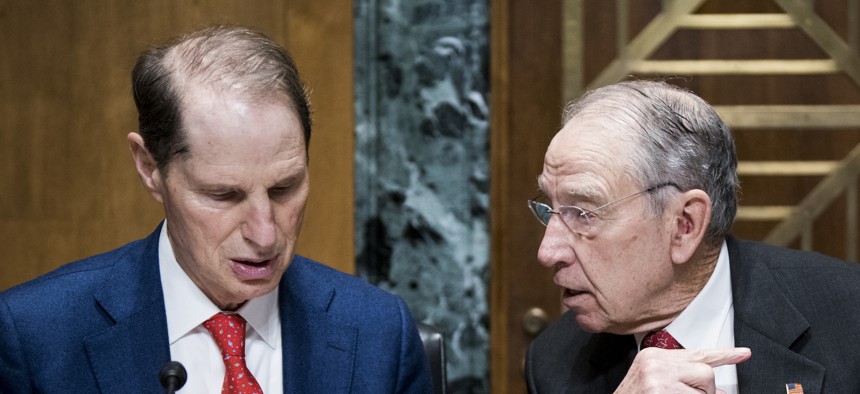 Sen. Chuck Grassley, R-Iowa (right) speaks with Sen. Ron Wyden, D-Ore., (left) before the start of a hearing on Feb. 2, 2019. They are spearheading the Senate version of the IRS Whistleblower Program Improvement Act.