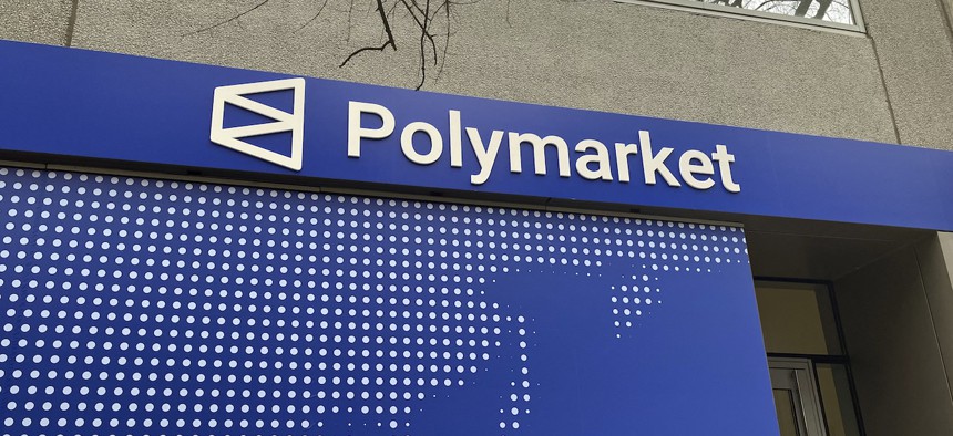 The Polymarket logo is seen outside their new location called "The Situation Room" during its opening day in Washington, D.C., on March 20, 2026. Prediction market platforms have rapidly broken into the mainstream in the United States, positioning themselves as an alternative to both traditional polling and licensed sports betting.