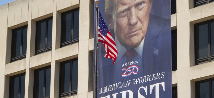 A banner with a portrait of President Donald Trump is displayed on the front of the Labor Department's Frances Perkins Building on May 30, 2026, in Washington, D.C. DOL saw a significant spike in its social media engagement between 2024 and 2025.