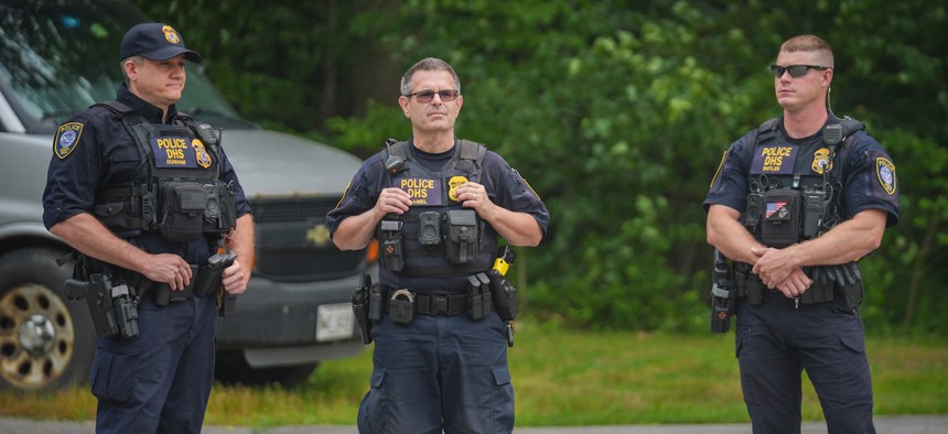 DHS officers stand guard outside of a federal immigration office after a man was fatally shot by Immigration and Customs Enforcement agents, on July 14, 2026 in Scarborough, Maine. A nationwide surge of immigration enforcement has included federal agents shooting and killing protesters, observers and immigrants. 