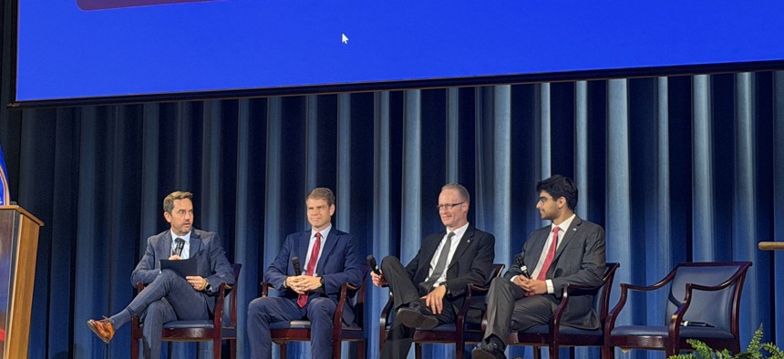 (L to R) GSA Deputy Administrator Mike Lynch speaks with GSA Senior Advisor Matt Batzel, GSA CIO David Shive and Commerce Department Chief Technology Officer Moksh Jawa at the Federal Emerging Technology Showcase held on July 30 at the Interior Department.