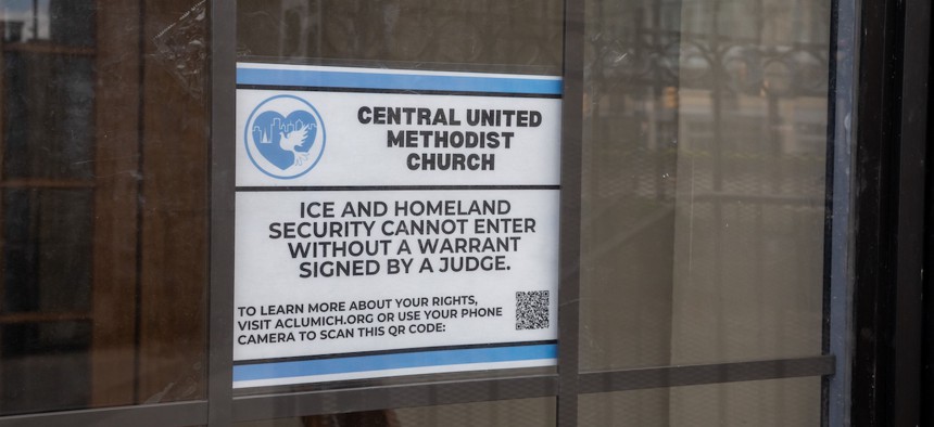 A sign on the door of Central United Methodist Church in Detroit in 2025 prohibits entry of immigration officials without a signed warrant. The recent ruling only applies to the houses of worship that sued the federal government.