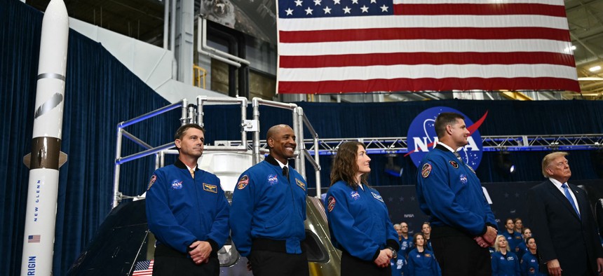 NASA astronaut and commander Reid Wiseman, NASA astronaut and pilot Victor Glover, NASA astronaut and mission specialist Christina Koch and CSA astronaut and mission specialist Jeremy Hansen stand by President Donald Trump during a Congressional Space Medal of Honor presentation at NASA Lyndon B. Johnson Space Center in Houston, Texas, on August 28, 2026.