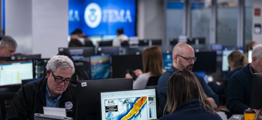 A worker in the National Response Coordination Center looks at a map of the approaching winter storm in the National Response Coordination Center at the Federal Emergency Management Agency headquarters on Jan. 24, 2026 in Washington, D.C. Trump suggested early in his second term that FEMA might “go away.”