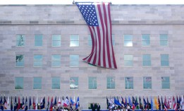 An American flag is unfurled on Sept. 11, 2002 in Arlington, Va., from the top of the Pentagon over the reconstructed section, which was damaged by American Airlines flight 77. President George W. Bush and Defense Secretary Donald Rumsfeld joined victims, families and workers in a remembrance ceremony on the first anniversary of the 9/11 terrorist attacks.