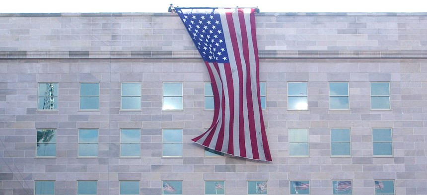 An American flag is unfurled on Sept. 11, 2002 in Arlington, Va., from the top of the Pentagon over the reconstructed section, which was damaged by American Airlines flight 77. President George W. Bush and Defense Secretary Donald Rumsfeld joined victims, families and workers in a remembrance ceremony on the first anniversary of the 9/11 terrorist attacks.
