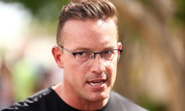 Commentator Benny Johnson speaks at a makeshift memorial for right-wing activist Charlie Kirk  in Phoenix, Ariz., on Sept. 19, 2025. Johnson spoke at a recent Office of Personnel Management recruiting event at the University of Florida. 
