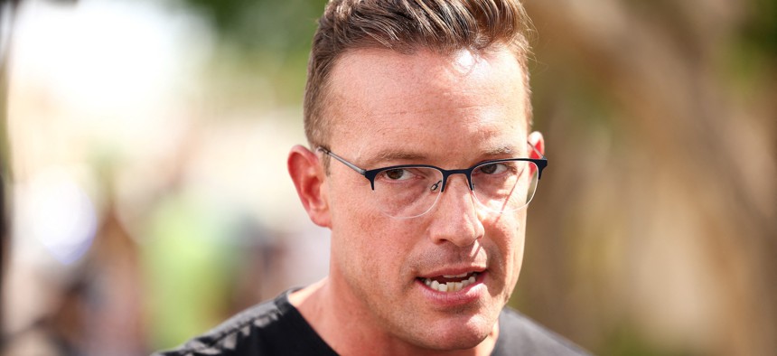 Commentator Benny Johnson speaks at a makeshift memorial for right-wing activist Charlie Kirk in Phoenix, Ariz., on Sept. 19, 2025. Johnson spoke at a recent Office of Personnel Management recruiting event at the University of Florida.