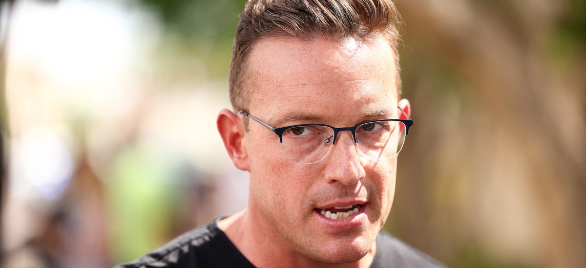 Commentator Benny Johnson speaks at a makeshift memorial for right-wing activist Charlie Kirk  in Phoenix, Ariz., on Sept. 19, 2025. Johnson spoke at a recent Office of Personnel Management recruiting event at the University of Florida. 
