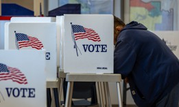 A Kansas resident fills out his ballot for the midterms on the first day of in-person voting in Lawrence, Kan., on Oct. 14. Around a dozen former federal employees are candidates in upcoming general congressional elections. 