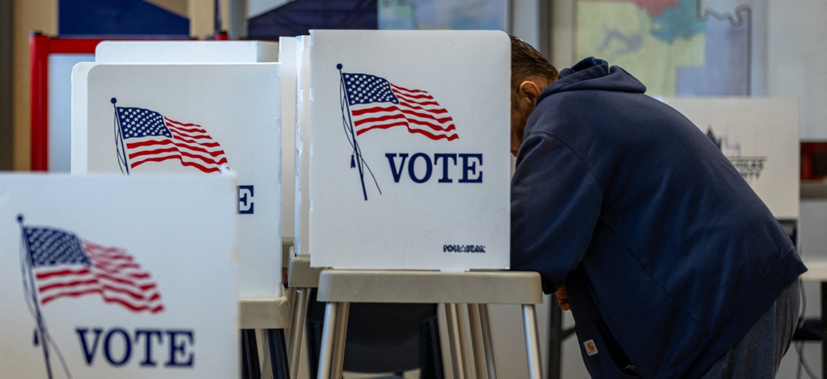 A Kansas resident fills out his ballot for the midterms on the first day of in-person voting in Lawrence, Kan., on Oct. 14. Around a dozen former federal employees are candidates in upcoming general congressional elections. 