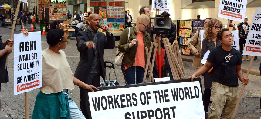 Uber and Lyft drivers protest outside the New York Stock Exchange in May 2019.