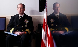 Navy Rear Adm. John Polowczyk, supply chain task force lead at FEMA, listens as President Trump speaks at the White House on April 13 about the government's response to the COVID-19 pandemic.  