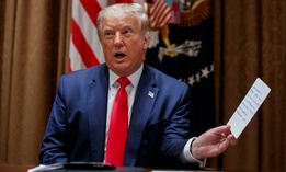 President Trump speaks as he holds a message from the CEO of the Tennessee Valley Authority during a meeting with U.S. tech workers on Aug. 3 , before signing an executive order on hiring American.