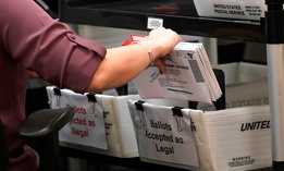 An election worker sorts vote-by-mail ballots at the Miami-Dade County Board of Elections on Oct. 26 in Doral, Fla.