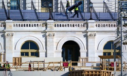 Construction crews work on the platforms where President-elect Biden will take the oath of office, at the Capitol on Nov. 18. 
