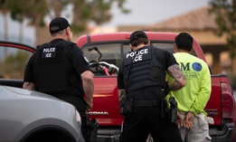 U.S. Immigration and Customs Enforcement officers detain a man during an operation in Escondido, California, in July 2019.