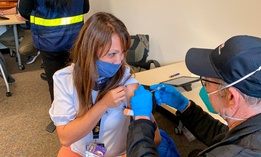 Grace John, who works at a school in San Lorenzo, gets a COVID-19 shot at a mobile vaccination clinic run by the Federal Emergency Management Agency and the state in Hayward, Calif., on Friday, Feb. 19, 2021.